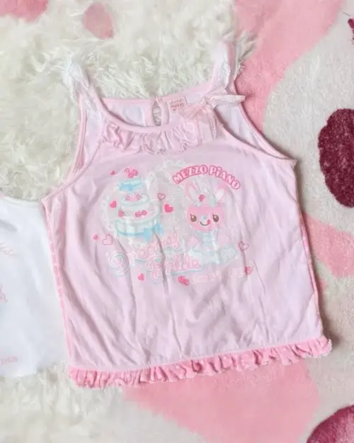 Pink mezzo piano tank top with bunny and cake graphics. Cutecore aesthetic style.