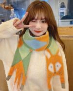 Woman wearing a cute fox scarf with a cottage aesthetic pattern.