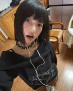 Off shoulder dark pullover grunge aesthetic sweater worn by a person.