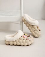 Casual fluffy foam slippers with a plush, white lining and decorative embellishments.