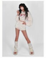 Woman wearing a kawaii fluffy pajamas set, featuring a hooded top and shorts, with matching slippers.