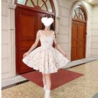 Woman wearing a Bow Floral Dress - Soft Girl Aesthetic, featuring a floral print and spaghetti straps.