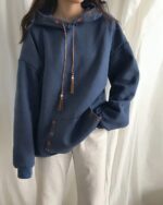 Blue ethno-chic hoodie featuring embroidered details and tassel pulls.