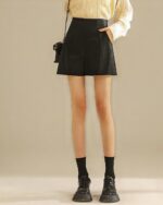 Black vegan leather vintage aesthetic shorts, high waist style.