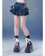 Blue denim mini skirt with pink bow, a trendy y2k aesthetic skirt.