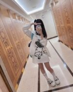 Model wearing a playful neko cat t-shirt with kawaii illustrations.