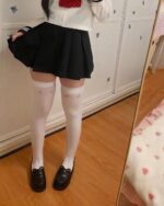 Kawaii Collection of cute stockings - Kaomoji Edition white knee-high socks with floral pattern, worn with school uniform.