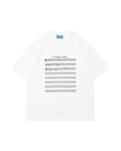 White tee shirt featuring an artsy aesthetic design with musical notation and text: 'To Hidden Valley'.
