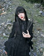 Black laced short dress, gothic lolita dress worn by a model outdoors.