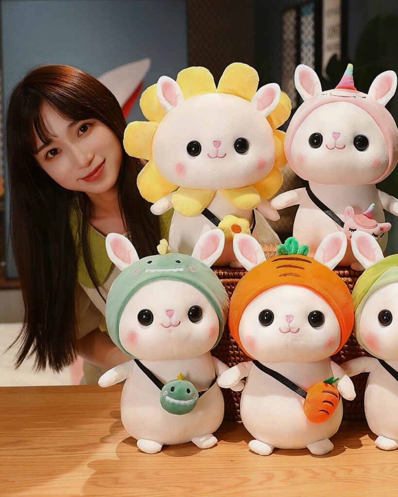 Kawaii bunny plushie Cotton the Adventurous Rabbit wearing a hat with a frog and carrot accessories.