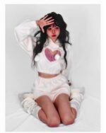 Model wearing a kawaii fluffy pajamas set; cropped cardigan and shorts with leg warmers.