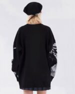 Back view of a black animecore sweater with graphic details.
