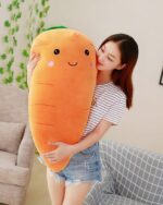 A cute kawaii carrot plushie being held by a person.