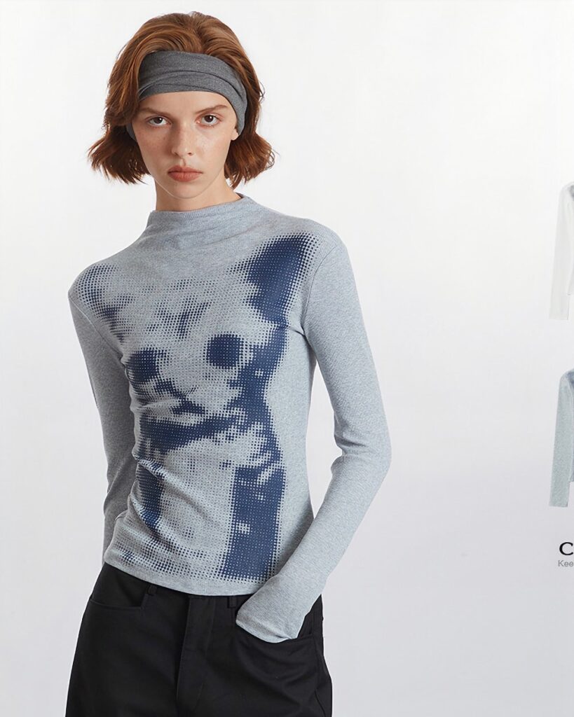 Gray el gato sweatshirt with a graphic print, modeled by a woman.