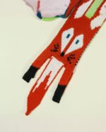 Close-up of a red fox scarf with white detailing, showcasing the cute fox scarf design.