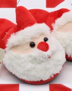 Close-up of red santa cotton slippers with a fluffy face and hat, Christmas Collection.