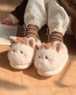 Close-up of kawaii cat slippers with fluffy details and socks.