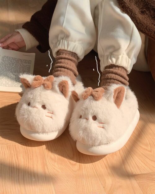 Close-up of kawaii cat slippers with fluffy details and socks.