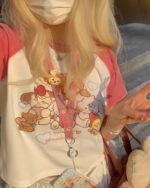 Cute summer pink t-shirt featuring a Harajuku aesthetic print with character illustrations.