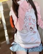 Pink Pastel Attack Yume Kawaii shirt featuring cute dog and fruit illustrations on a pink background.