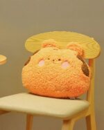 Orange kawaii animal plushie cushion on a wooden chair.