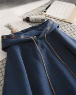 Blue ethno-chic hoodie featuring gold embroidered details and drawstring.