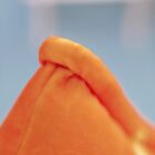 Close-up of an orange Cheesy Puffs plushie, soft and textured.