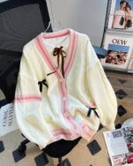 Cream-colored kawaii bow sweater with a plaid pattern and decorative ties.