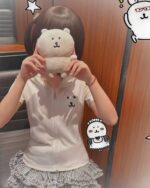 Person wearing a white jojifuku aesthetic hoodie with bear embroidery, casual style.