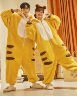 Couple wearing yellow dino-shark jumpsuit with brown details and slippers.