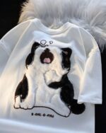 White t-shirt featuring a cute, sleepy cat design. Japanese-style sleepy cat t-shirt.