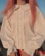 Close-up of a white angel kawaii dress shirt with ruffled collar and cuffs.