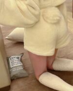 Close-up view of kawaii hooded pajamas featuring a plush, cream-colored design.