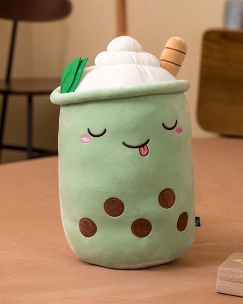Cute green boba milk tea plush toy filled with soft material and featuring a smiling face.