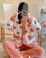 Pink kawaii strawberry pajamas set featuring a fluffy, patterned design. Comfortable loungewear.