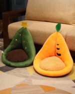 Two kawaii fruit cushions: a green pear and an orange carrot, both with plush interiors.