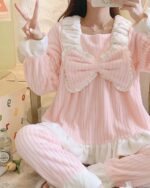 Pink kawaii flannel pajamas with bow details and a plush texture.