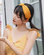 Woman holding a kawaii fruit bottle, featuring a colorful design.