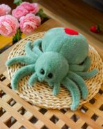 Spooky cute spider plush resting on a woven coaster.
