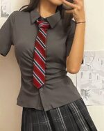 Gray shirt and black pleated skirt, preppy aesthetic uniform outfit.
