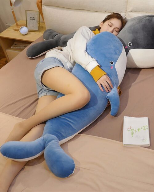 Blue kawaii whale plushie being held by a person, soft and cuddly.