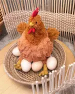 Soft, brown fat chicken plushie with six plastic eggs on a tray.