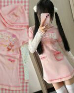 Pink pastel hooded dress with a long-sleeved design and character embroidery.