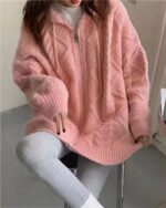 Pastel hooded sweater featuring a soft, fluffy knit texture and a half-zip closure.