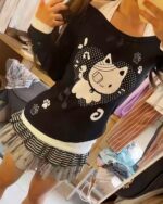 Black neko off-shoulder t-shirt with paw prints and a cute cat design.
