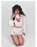 Model wearing a white kawaii fluffy pajamas set with a heart design.