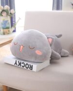 Grey Kawaii Mochi Peach Cat Plushie lying on a white box.