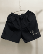 Black kaomoji aesthetic shorts, made from cotton, with a printed design.