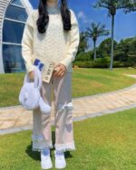 Laced Casual Pants - Kawaii Clothes pink pants with bows and lace trim, worn by a person.