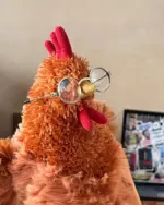 A plush fat chicken wearing round spectacles, a cute fat chicken plushie.